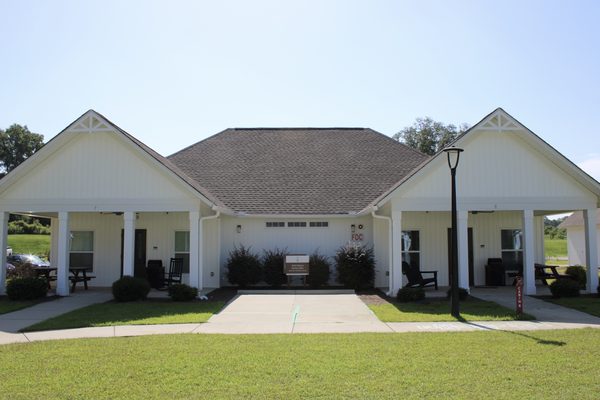 A white cabin with two front porches at Camp Cole