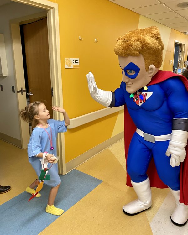 Mighty Max high-fives a young patient at the Children's Hospital in Columbia, SC