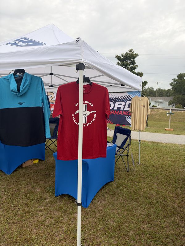 Ford-branded tent with Ford Mustang T-shirts on display at the 46th Annual Mustang & Ford Show in Elgin, SC